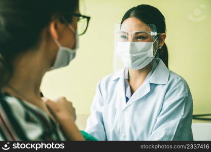 Young woman visits skillful doctor at hospital for vaccination . Covid 19 and coronavirus vaccination center service concept .. Young woman visits skillful doctor at hospital for vaccination