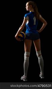Young woman volleyball player isolated on black