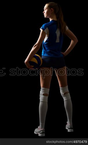 Young woman volleyball player isolated on black
