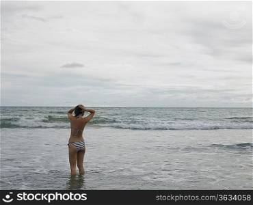 Young Woman Wading in Ocean