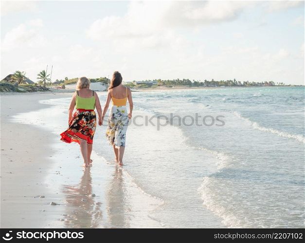 Young woman walking along the coast of the Atlantic Ocean. Close-up. Vacation and travel concept. Young woman walking along the coast of the Atlantic Ocean