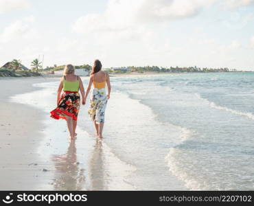 Young woman walking along the coast of the Atlantic Ocean. Close-up. Vacation and travel concept. Young woman walking along the coast of the Atlantic Ocean