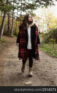 young woman walking forest