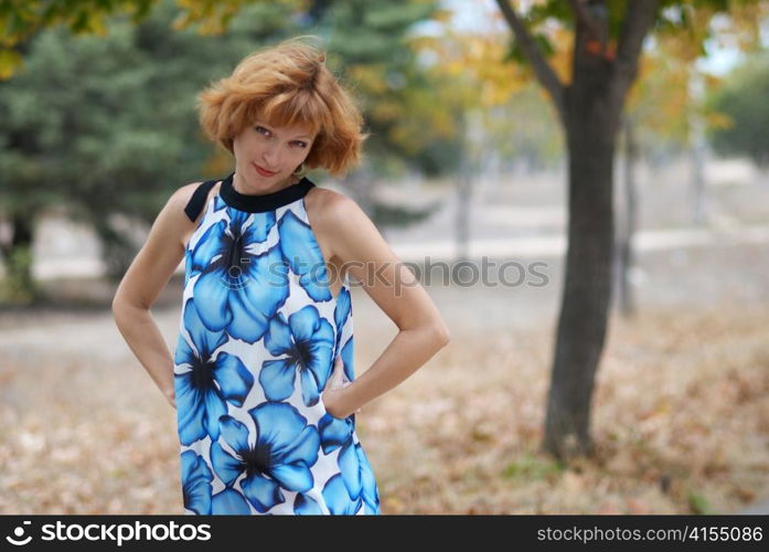 Young woman walking in autumn park, soft background