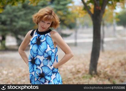Young woman walking in autumn park, soft background