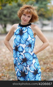 Young woman walking in autumn park, soft background