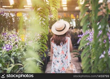 Young woman walking in the orchid garden