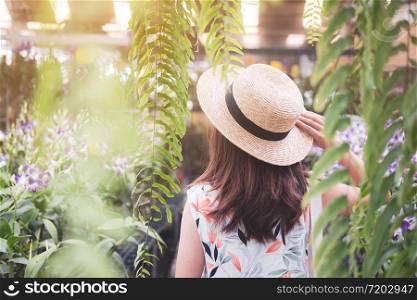 Young woman walking in the orchid garden