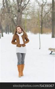 Young woman walking in winter park