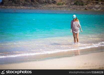 Young woman walking on beach