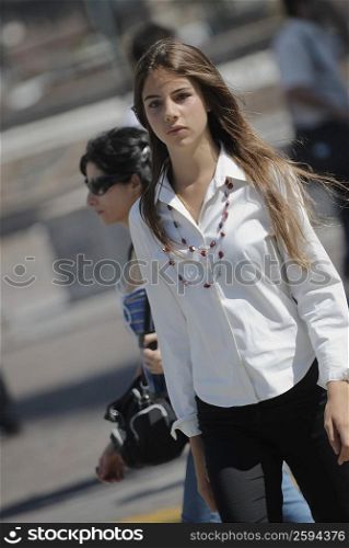 Young woman walking on the road