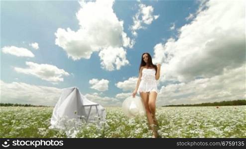 Young Woman Walking Through Summer Field, Front View