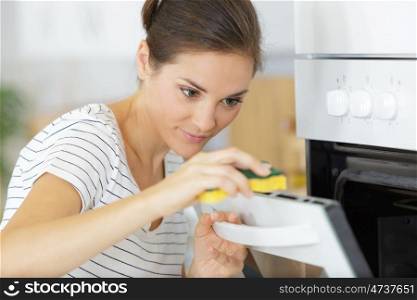 young woman washes a microwave