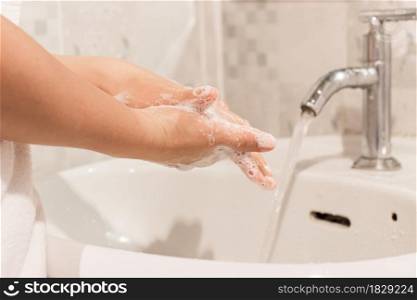 Young woman washing hands rubbing with soap prevention for coronavirus, Close up