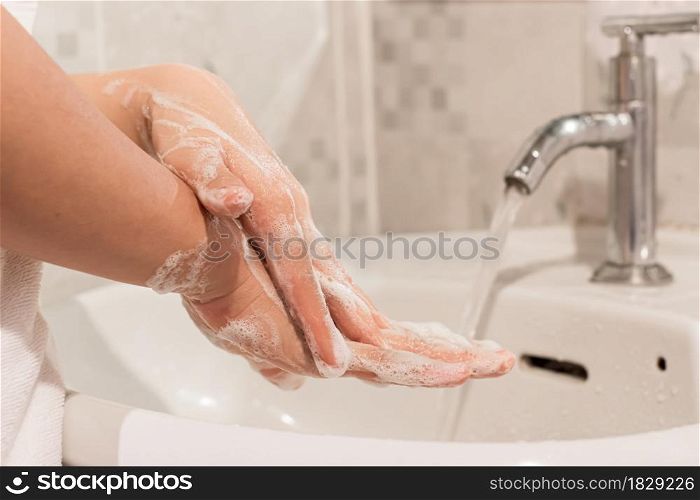 Young woman washing hands rubbing with soap prevention for coronavirus, Close up