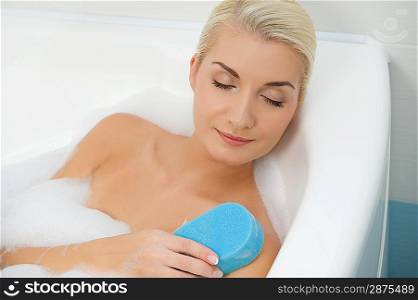 Young woman washing in bathroom
