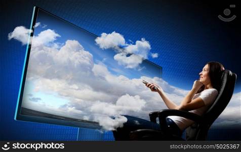 Young woman watching 3d tv. Image of young woman in armchair watching 3d tv