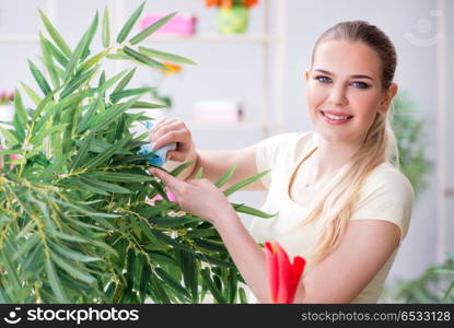 Young woman watering plants in her garden