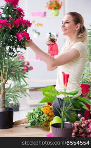 Young woman watering plants in her garden