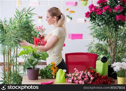 Young woman watering plants in her garden