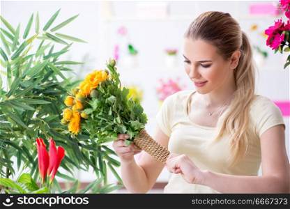 Young woman watering plants in her garden