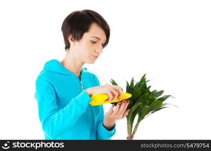 Young woman watering plants isolated on white