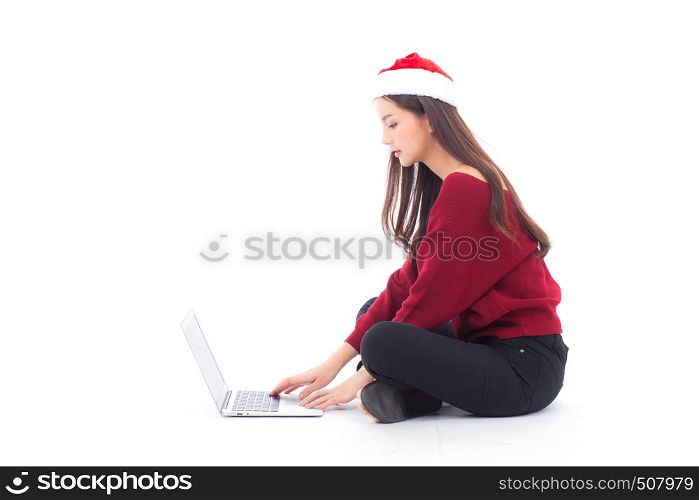 Young woman wear santa hat sitting labtop with internet shopping in season christmas holiday, girl shoping online on notebook in xmas, celebration concept.