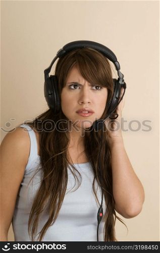Young woman wearing a headset and looking serious