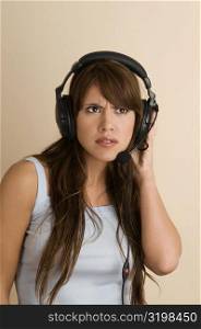 Young woman wearing a headset and looking serious