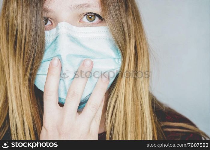Young woman wearing a protective face mask