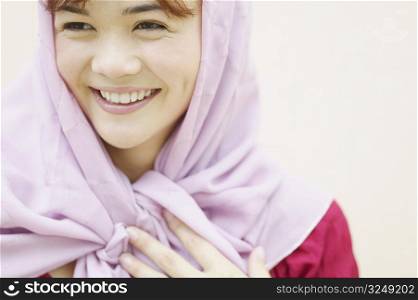 Young woman wearing a scarf smiling