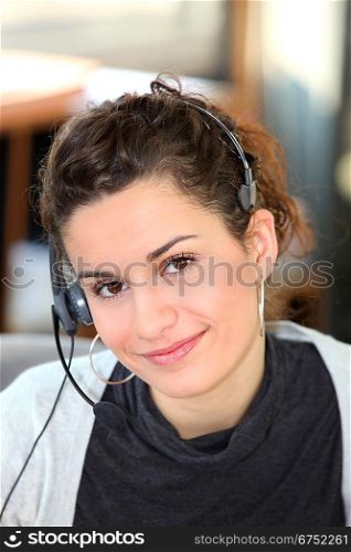 Young woman wearing a telephone headset