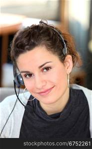 Young woman wearing a telephone headset
