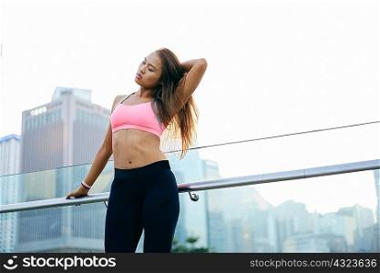 Young woman wearing crop top with hand in hair, Hong Kong