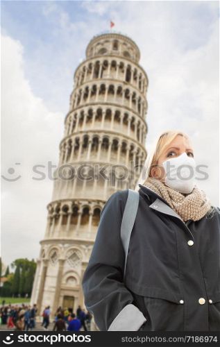 Young Woman Wearing Face Mask Walks Near The Leaning Tower of Pisa In Italy.