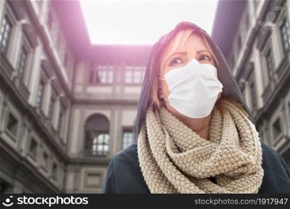 Young Woman Wearing Face Mask Walks Near the Uffizi Gallery In Italy.