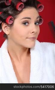 Young woman wearing hair curlers