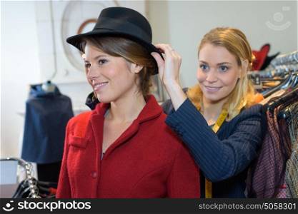 young woman wearing hat in the clothing store