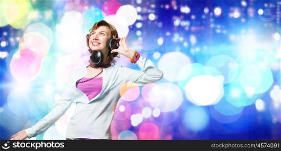 Young woman wearing headphones against bokeh background