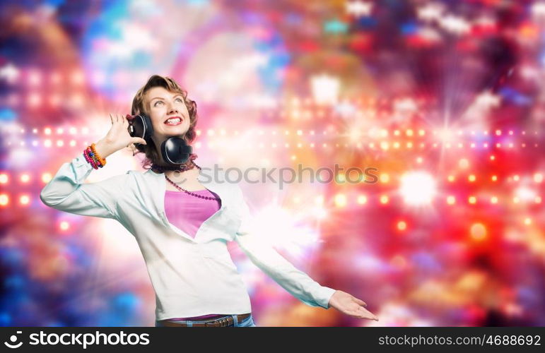 Young woman wearing headphones against bokeh background