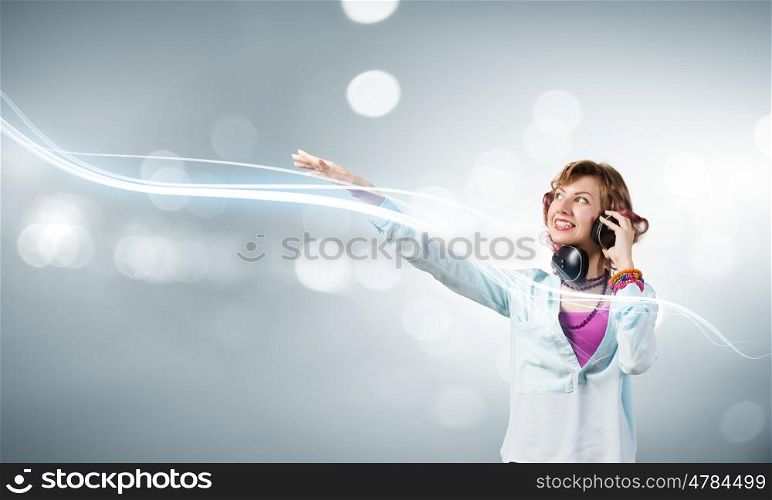 Young woman wearing headphones against bokeh background