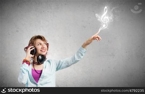Young woman wearing headphones and enjoying music