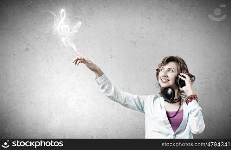 Young woman wearing headphones and enjoying music
