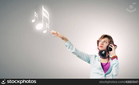 Young woman wearing headphones and enjoying music