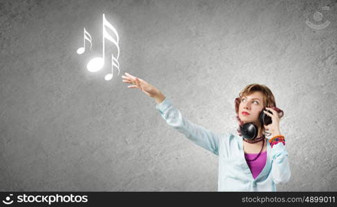 Young woman wearing headphones and enjoying music