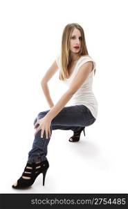 young woman wearing jeans crouching . young woman wearing jeans crouching on white background
