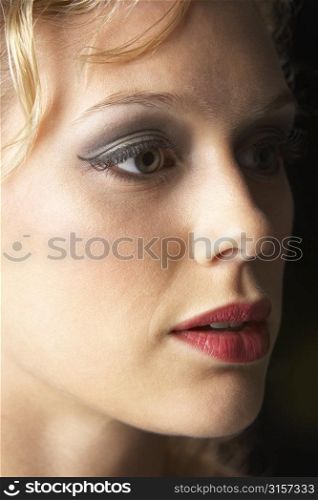 Young Woman Wearing Make-Up, Looking Thoughtful