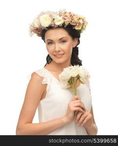 young woman wearing wreath of flowers and bouquet