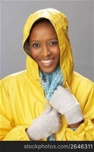 Young Woman Wearing Yellow Raincoat In Studio