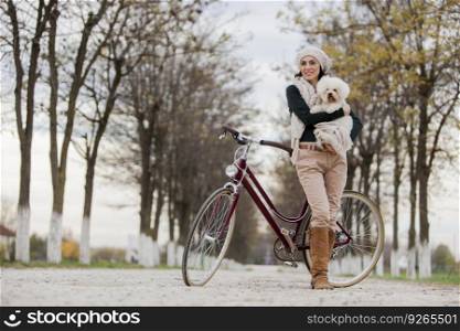 Young woman with a bicycle and a cute dog